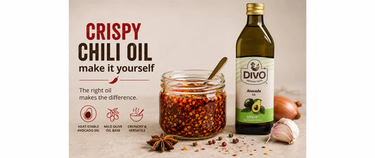 Homemade crispy chili oil in a jar beside DIVO avocado oil and spices.